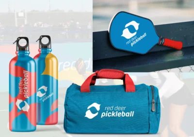 Red Deer Pickleball Club brand examples - bottles, bags and a racket
